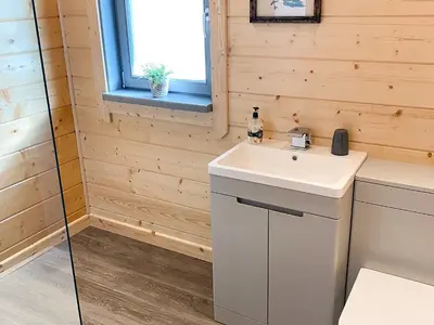 a bathroom with a white sink and a window at Cedar Lodge - Uk30008 in Lindal in Furness