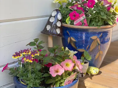 two vases filled with flowers and a bird house at Cedar Lodge - Uk30008 in Lindal in Furness