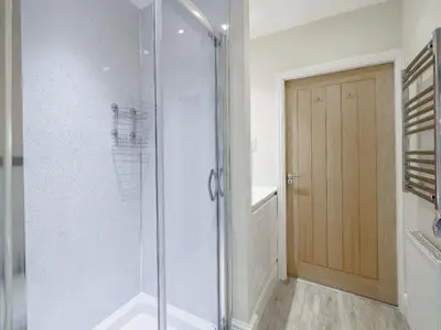 a shower with a glass door in a bathroom at Adamsons Barn in Inglewhite