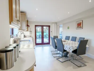 a kitchen with a table and chairs in a kitchen at Adamsons Barn in Inglewhite