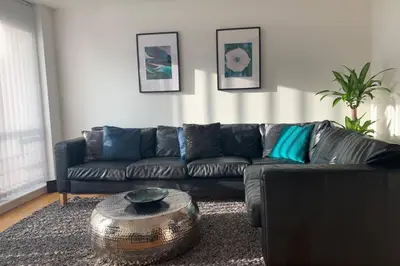 a living room with a couch and a table at Duke Street - Liverpool city centre apartment in Liverpool