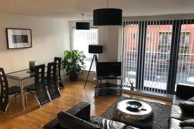 a living room with a couch and a table and chairs at Duke Street - Liverpool city centre apartment in Liverpool
