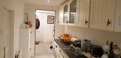 a kitchen with a sink and a white refrigerator at Amazing Double Liverpool in Liverpool