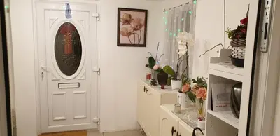 a white door in a white room with flowers at Amazing Double Liverpool in Liverpool