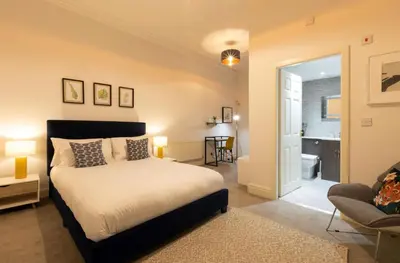 a bedroom with a bed and a living room at Fulwood Heights in Preston
