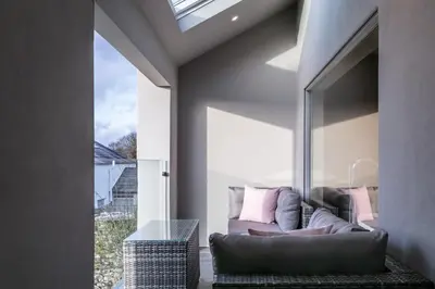 a living room with a couch and a window at The Old Hay Shed in Cartmel