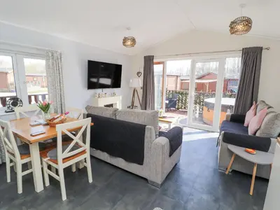 a living room with a couch and a table at Duckling Lodge in Carnforth