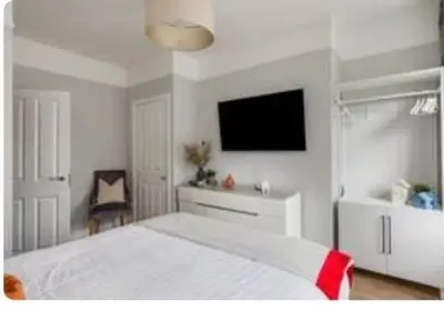 a bedroom with a white bed and a flat screen tv at Liverpool Georgian Quarter 1 Bed Apartment Sleeps 4 in Liverpool