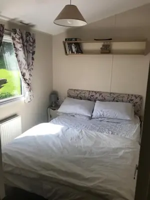 a bedroom with a bed in a small room at Deluxe 3 bedroomed caravan on Marton Mere with CH DG and decking in Blackpool