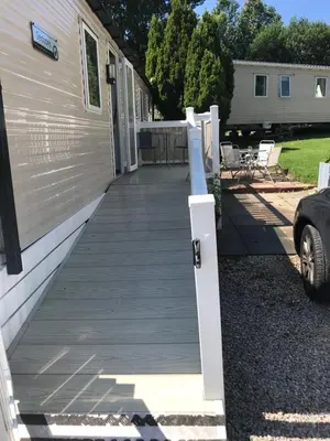 a wooden walkway leading to the side of a house at Deluxe 3 bedroomed caravan on Marton Mere with CH DG and decking in Blackpool