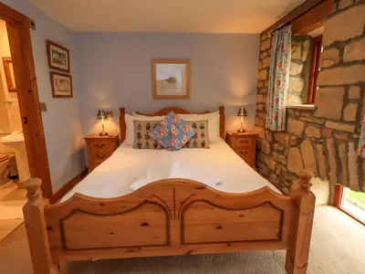 a bedroom with a wooden bed in a room at Usherwoods Barn in Lancaster