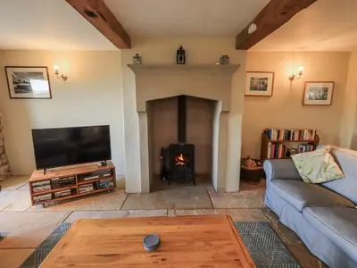 a living room with a couch and a fireplace at Usherwoods Dairy in Lancaster