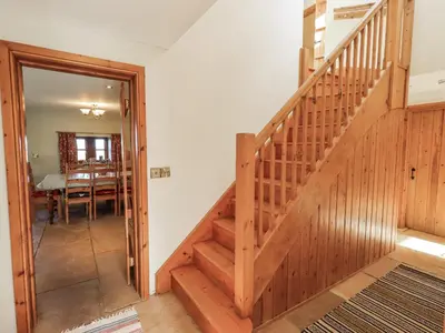 a hallway with stairs leading to a dining room at Usherwoods Dairy in Lancaster