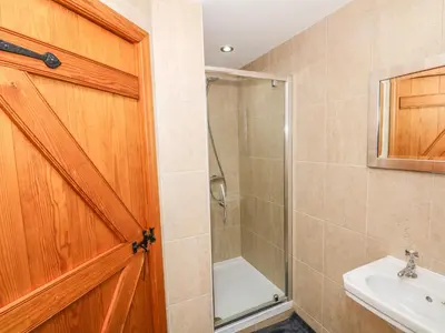 a bathroom with a shower and a sink at Rose Hips Barn in Chorley