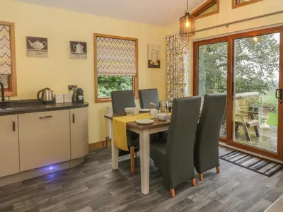 a kitchen and dining room with a table and chairs at Nicky Nook Lodge in Preston
