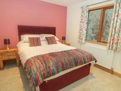 a bedroom with a bed and a window at Nicky Nook Lodge in Preston