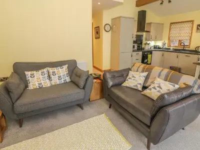 a living room with two chairs and a couch at Nicky Nook Lodge in Preston
