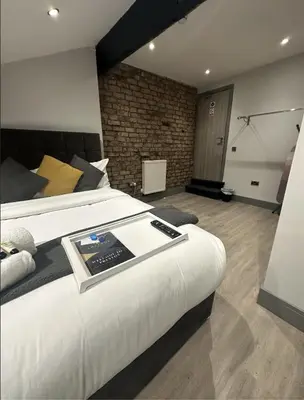 a hotel room with a bed with a book on it at 6Adelphi in Preston