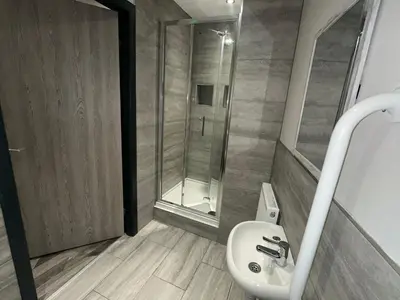 a bathroom with a white sink and a shower at 6Adelphi in Preston