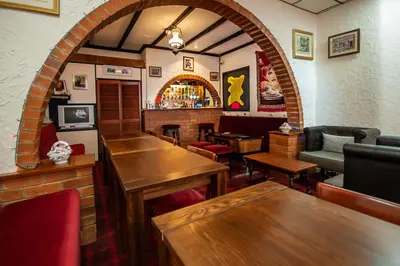a restaurant with tables and chairs and a bar at The Ferndale Hotel in Blackpool