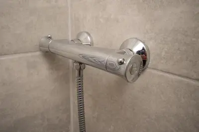 a shower head in a bathroom with a mirror at The Ferndale Hotel in Blackpool