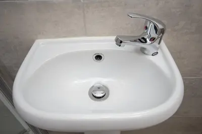 a white sink with a faucet in a bathroom at The Ferndale Hotel in Blackpool