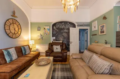 a living room with two couches and a table at Beach House in Lytham St Annes