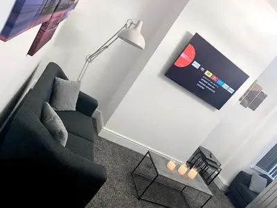 a living room with a couch and a lamp at Victory hot tub house in Blackpool