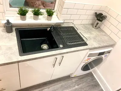 a kitchen counter with a sink and potted plants at Victory hot tub house in Blackpool