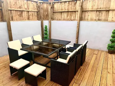 a dining table and chairs on a wooden floor at Victory hot tub house in Blackpool