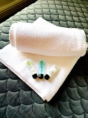 two toothbrushes and a towel on a bed at Victory hot tub house in Blackpool