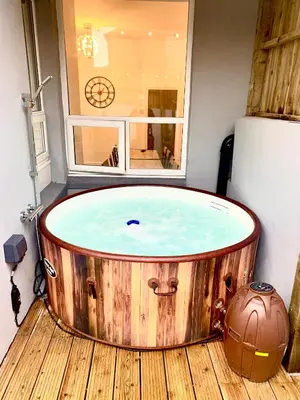 a hot tub in a room with a window at Victory hot tub house in Blackpool