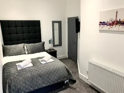 a bedroom with a bed with two towels on it at Victory hot tub house in Blackpool