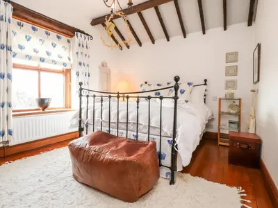 a bedroom with a bed with a metal frame at The Boot Room in Preston