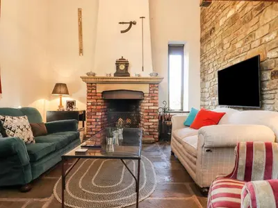 a living room with a couch and a fireplace at The Boot Room in Preston