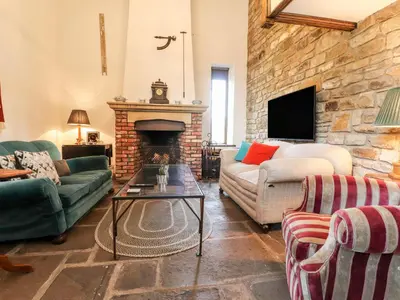 a living room with a couch and a fireplace at The Boot Room in Preston