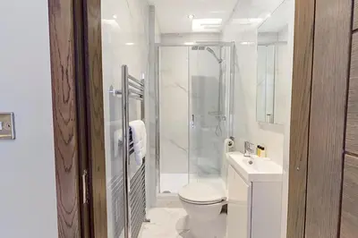 a bathroom with a shower and a toilet and a sink at The Arc Hotel in Liverpool