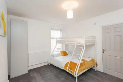 a bedroom with a bunk bed and a window at Cherry Property - Hornby Road in Blackpool