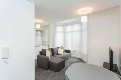 a living room with a couch and a table at Cherry Property - Hornby Road in Blackpool