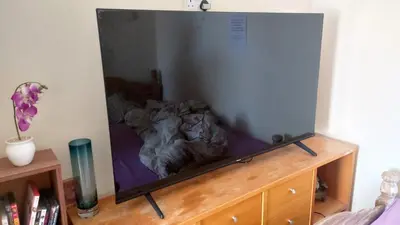 a large mirror on top of a wooden dresser at Phoenix Nights Guest House in Barrow in Furness