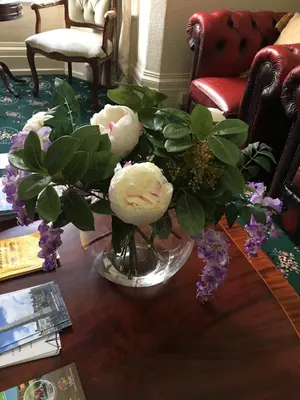 a vase filled with white flowers on a table at Adelphi Guest House in Southport
