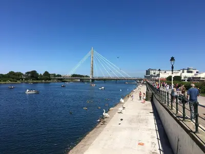 a group of people standing on a pier near the water at Adelphi Guest House in Southport