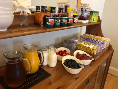 a wooden counter with various breakfast foods and drinks at Adelphi Guest House in Southport