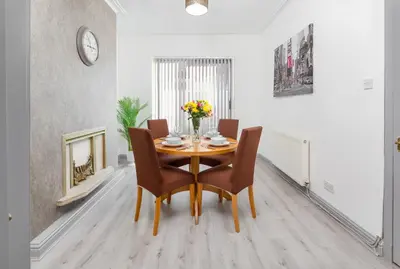 a dining room with a table and chairs at Superb Spacious House For Contractors & Families & Private Parking By Liverpool Short Stay in Liverpool