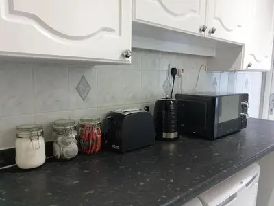 a kitchen counter with a toaster and a microwave at Superb Spacious House For Contractors & Families & Private Parking By Liverpool Short Stay in Liverpool