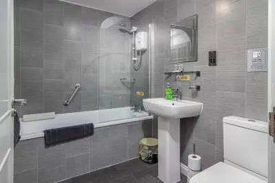 a bathroom with a sink and a shower and a toilet at 2 Bedrooms Sleeps 6 Near Top Blackpool Attractions in Blackpool