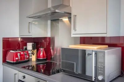 a kitchen with a stove and a microwave at 2 Bedrooms Sleeps 6 Near Top Blackpool Attractions in Blackpool