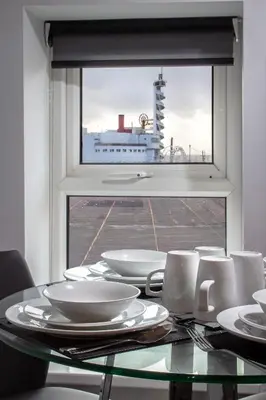 a glass table with white plates and a window at 2 Bedrooms Sleeps 6 Near Top Blackpool Attractions in Blackpool