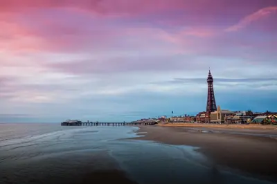 a view of a beach with a pier and a lighthouse at 2 Bedrooms Sleeps 6 Near Top Blackpool Attractions in Blackpool