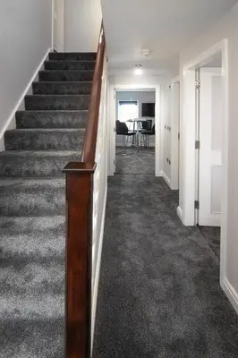 a hallway with a staircase with a stair railing at 2 Bedrooms Sleeps 6 Near Top Blackpool Attractions in Blackpool